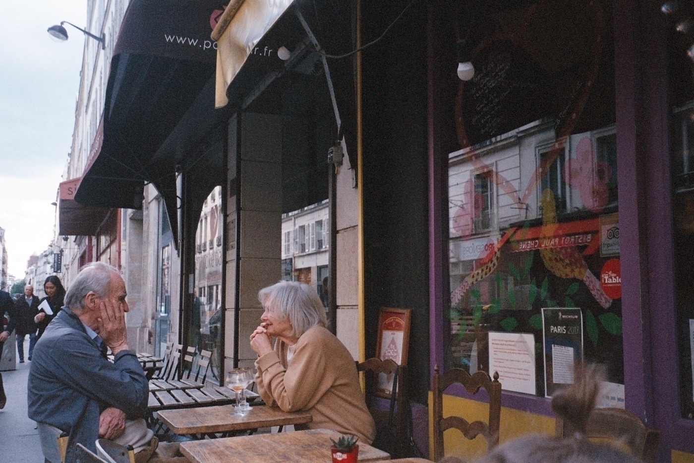 Couple at a cafe in Paris. Photo taken with Leica Z2X in Paris by Josh Withers.